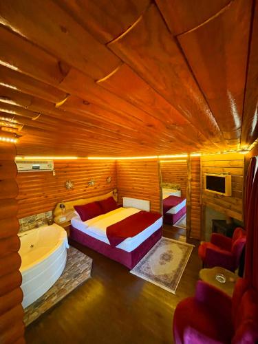 a bedroom with a bed and a tub in a room at Paradise Plus Ağva in Agva