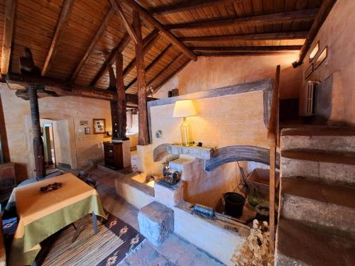a room with a table and a fireplace in a building at Dimora Migliori in Viagrande