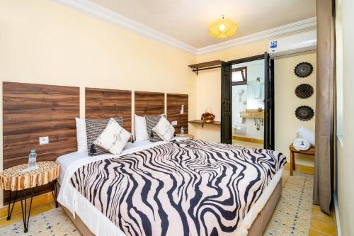 Postel nebo postele na pokoji v ubytování RIAD LA GAZELLE DU SUD