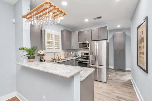 a kitchen with stainless steel appliances and a marble counter top at Walk to Museums Apartment - Near Med Center DT Rice & UH in Houston