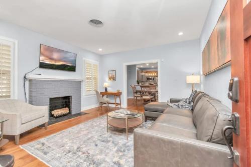 a living room with a couch and a fireplace at Walk to Museums Apartment - Near Med Center DT Rice & UH in Houston