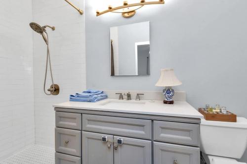 a bathroom with a sink and a mirror at Walk to Museums Apartment - Near Med Center DT Rice & UH in Houston