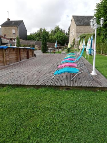 a group of umbrellas on a wooden deck at Gîte chezmadlou in Colondannes