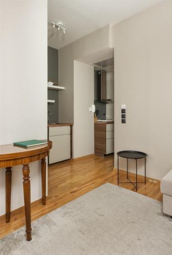 a living room with a table and a kitchen at Anvy Stylish Suites Ioannina in Ioannina