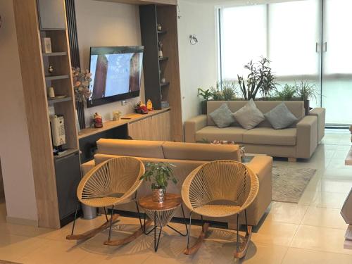 a living room with two chairs and a couch at Hotel Santa Clara Boutique in Montería