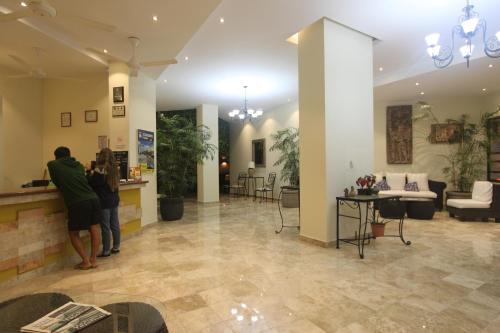 a group of people standing in a lobby at Hotel Los Itzaes by 5th av in Playa del Carmen