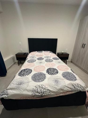 a bed with a comforter on it in a bedroom at Residencia en León en Privada in Echeveste