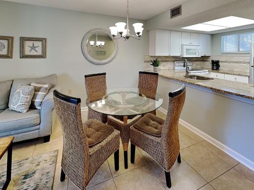 a kitchen and dining room with a table and chairs at Ocean Village Club N16 in Saint Augustine