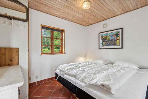 a bedroom with a large white bed in a room at Holiday Home Exuding Coziness And Comfort in Broager