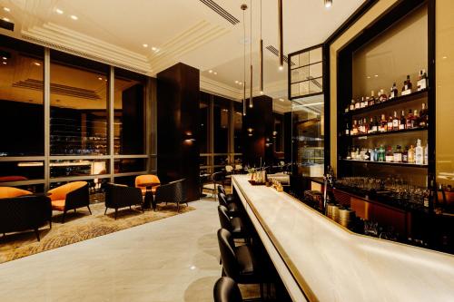 a bar with a long counter in a restaurant at Cinnamon Life at City of Dreams in Colombo