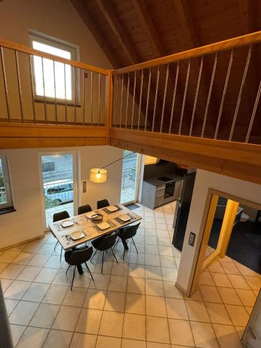 a dining room with a table and a staircase at 5-Seen-Loft mit 4-6 Schlafplätzen, Ferienwohnung Nähe Ammersee, neu eingerichtet in Kottgeisering