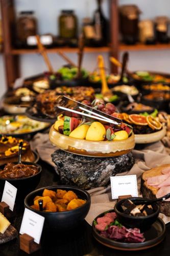 a table with many plates of food on it at Azur Hotel & Spa in Cordoba