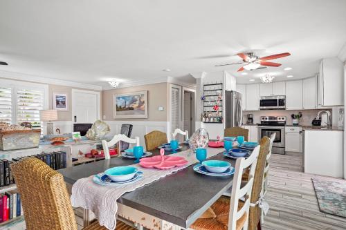 a kitchen and dining room with a table and chairs at Cozy Cape Cottage Gulf Access in Waterway Estates