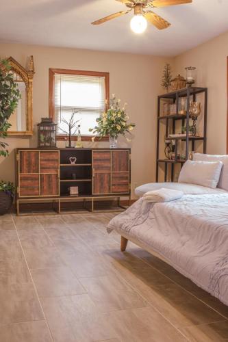 a bedroom with a bed and a dresser at Bustamante Ranch - Sovereign Lodge in McDonough