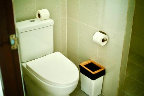 a bathroom with a toilet and two rolls of toilet paper at Three Trees Samui Resort - Sarocha Villa in Lamai