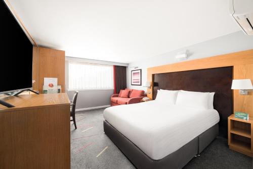 a hotel room with a bed and a television at Holiday Inn Aberdeen West by IHG in Westhill 