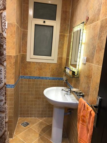 a bathroom with a sink and a mirror at Sharm El Sheikh nema downtown apartment in Sharm El Sheikh