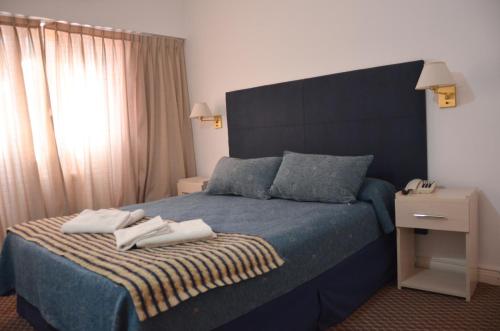 Una cama o camas en una habitación de Hotel Arenas