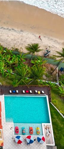 an overhead view of a swimming pool next to a beach at De Olho no Mar A única pousada de frente para o mar em Paracuru in Paracuru