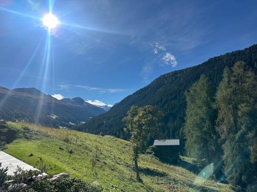 a view of a mountain with the sun in the sky at Luxury Apartment with Mountain Views in Davos in Davos