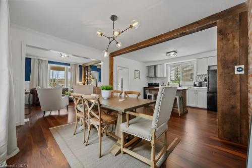 a kitchen and dining room with a table and chairs at 4 Bedroom Luxury House, Free Parking, Next to LRT, Kitchener Downtown, near Chicopee Ski Club in Kitchener