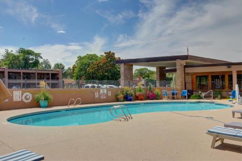 a swimming pool at a resort with a building at El Sendero Inn, an Ascend Collection Hotel in Santa Fe