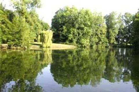 a view of a lake with trees and a body of water at Le Chalet Montégut in Moulins