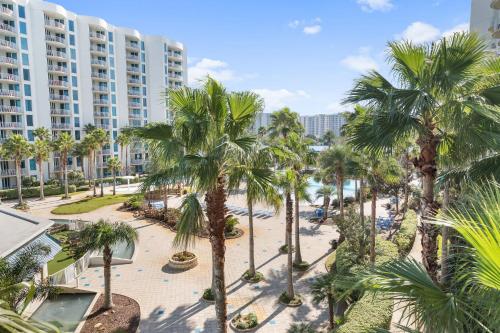 an aerial view of a resort with palm trees at Palms Resort 2 BR King Suite Poolside Shuttle in Destin