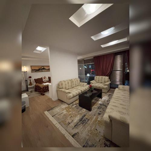 a living room with two couches and a couch at Theranda Hotel in Prizren
