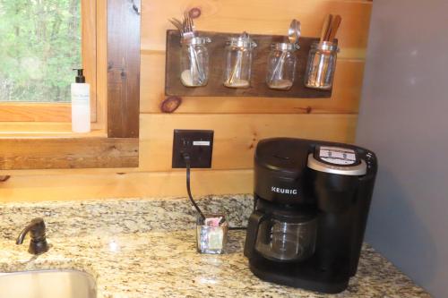 a coffee maker on a counter next to a sink at Cozy Couples Getaway with Hot Tub Fox Ridge Cabin in Whittier