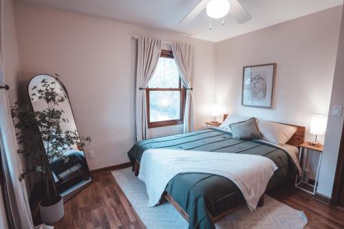 a bedroom with a bed and a window at Bigfoot's Hideout - A Hocking Hills Escape in Logan