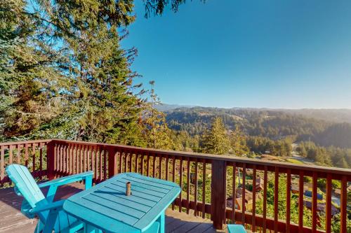 a blue table and chairs on a deck with a view at Whaleshead Ridge in Carpenterville