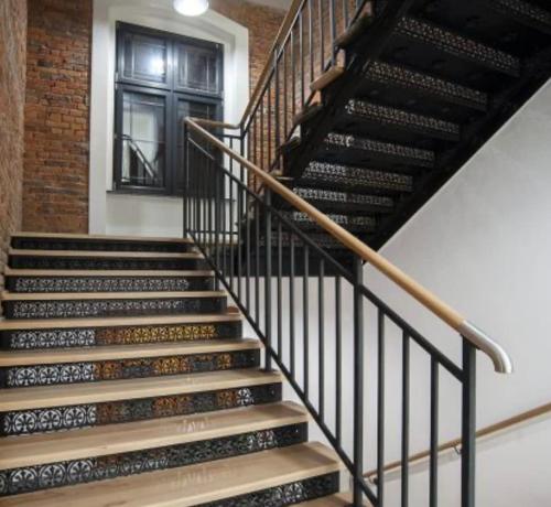 a set of stairs in a building with a window at Unique apartment in Ratibor in Racibórz