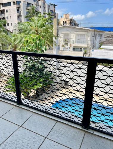 a balcony with a view of the ocean and buildings at Santa Rita Pousada in Guarujá