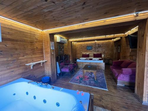 a living room with a tub and a bedroom at Paradise Plus Ağva in Agva