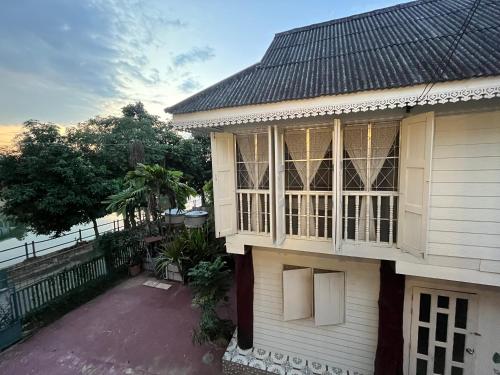 a house with a large window on the side of it at Once in Lampang Guesthouse in Lampang