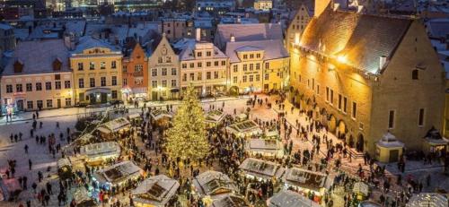 a christmas market in a city at night at Oldtown apartment next of Town hall square in Kesklinn
