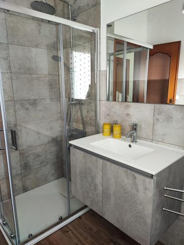 a bathroom with a sink and a shower at Appartamento in centro in Cairo Montenotte
