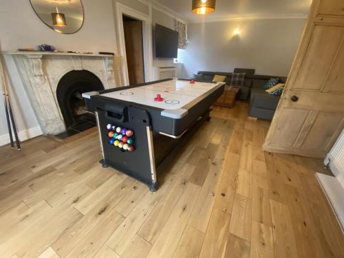 a ping pong table in the middle of a living room at Llanfair Hall, Dog Friendly, Cinema, Games Room, Hot Tub in Llanfairpwllgwyngyll