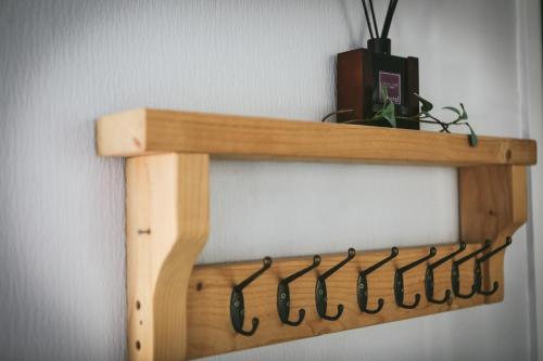 a wooden shelf hanging on a wall at Llanfair Hall, Dog Friendly, Cinema, Games Room, Hot Tub in Llanfairpwllgwyngyll