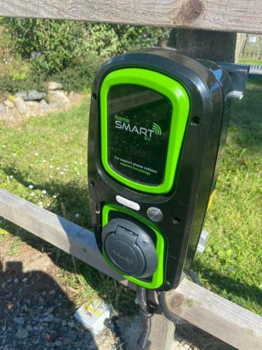 a green parking meter attached to a wooden fence at Llanfair Hall, Dog Friendly, Cinema, Games Room, Hot Tub in Llanfairpwllgwyngyll