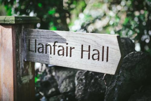 a sign that reads lantarha hall on a rock at Llanfair Hall, Dog Friendly, Cinema, Games Room, Hot Tub in Llanfairpwllgwyngyll