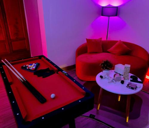 a room with a ping pong table and a couch at Sea Star Hotel Quy Nhon in Quy Nhon