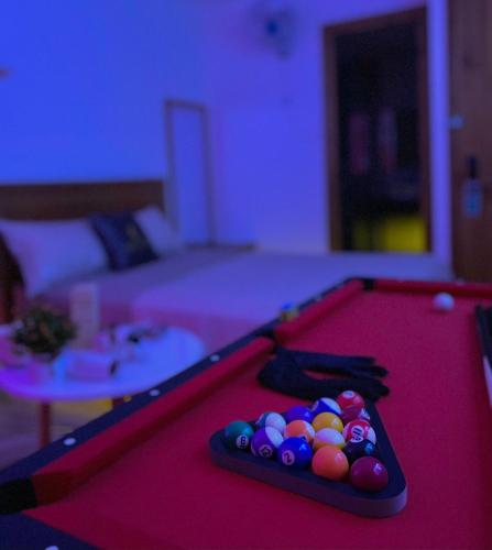 a red pool table with balls on top of it at Sea Star Hotel Quy Nhon in Quy Nhon