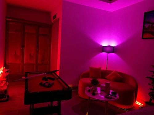 a living room with a couch and a pink light at Sea Star Hotel Quy Nhon in Quy Nhon