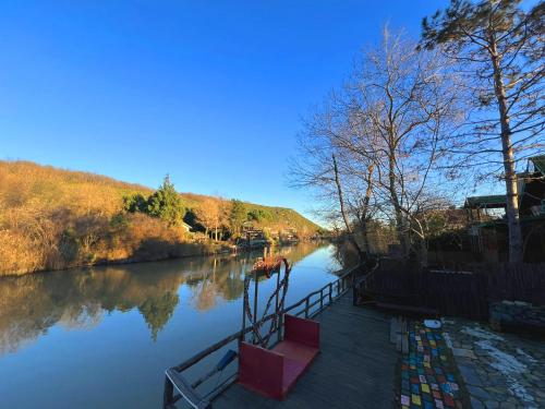 a river with a boat in the water at Paradise Plus Ağva in Agva