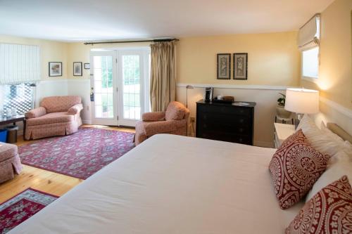 a bedroom with a bed and a living room at Swift House Inn in Middlebury