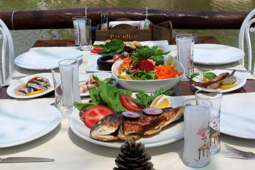 a table with plates of food on top of it at Paradise Plus Ağva in Agva