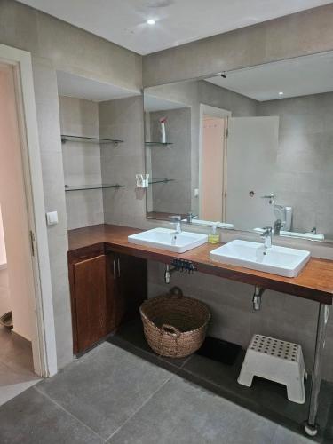 a bathroom with two sinks and a mirror at premium farmhouse with pool Rabat in Rabat