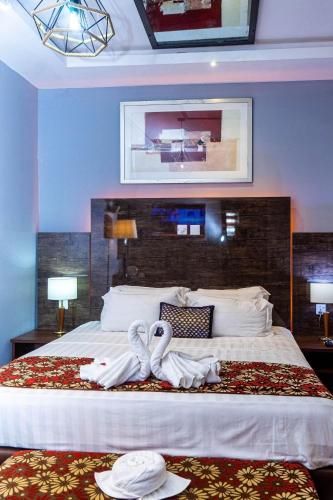 two swans made out of towels on a bed at Grand Casamora Hotel in East Legon